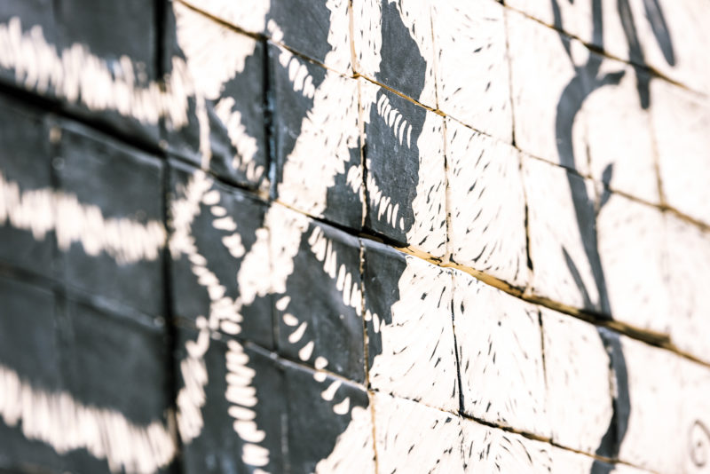 Artist Laura Jean McLaughlin's carved porcelain tile mural is visible on the back of the museum's facade.