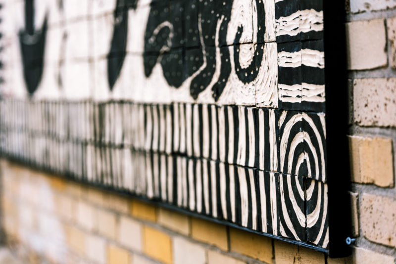 Artist Laura Jean McLaughlin's carved porcelain tile mural is visible on the back of the museum's facade.