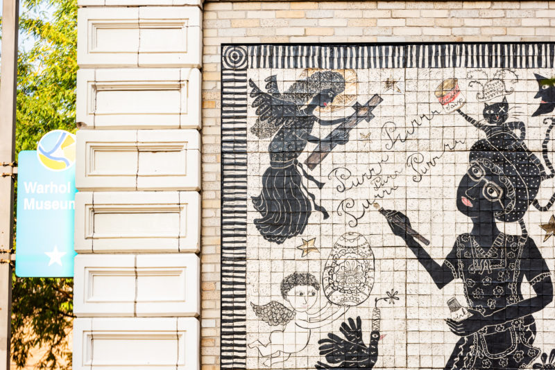 Artist Laura Jean McLaughlin's carved porcelain tile mural is visible on the back of the museum's facade.