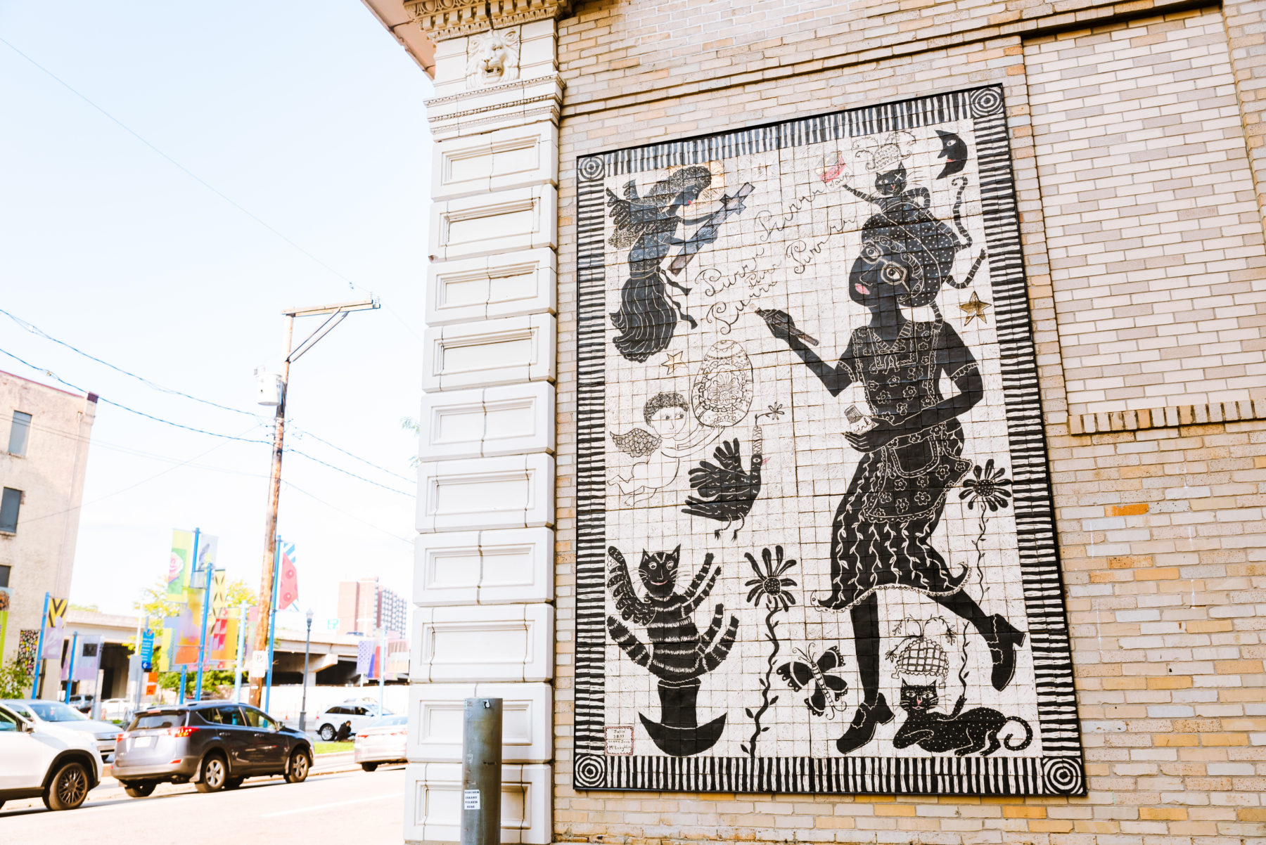 Artist Laura Jean McLaughlin's carved porcelain tile mural is visible on the back of the museum's facade.