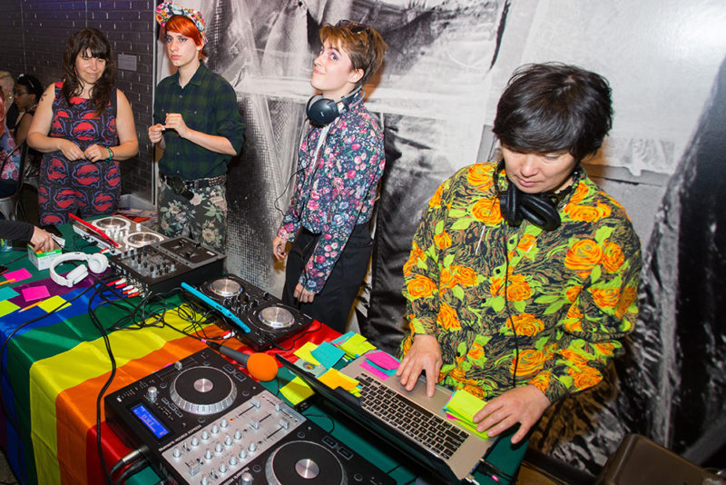 People DJ-ing in The Warhol entrance space during the LGBTQ Youth Prom.