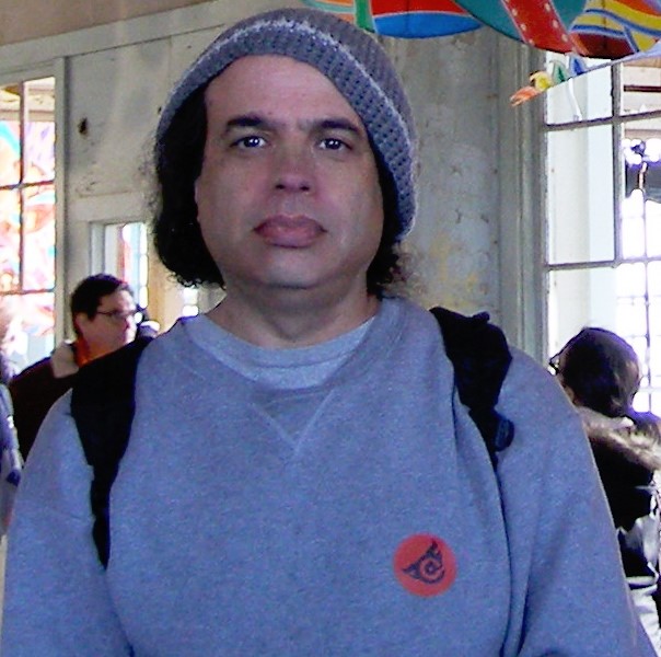 Richie Unterberger inside a building wearing a gray sweatshirt and gray hat.