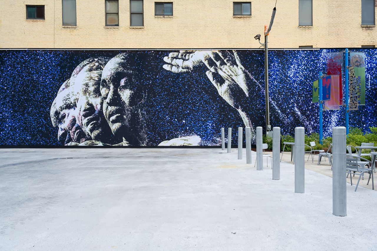 Large-scale fabric mural that runs the length of a building.