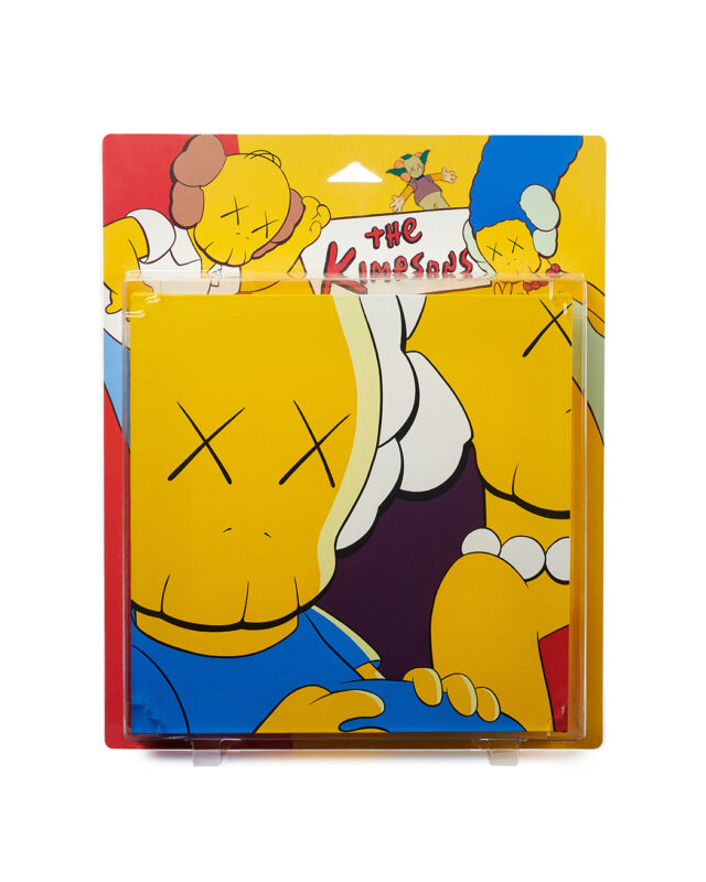 Sculpture of retail packaging with the Kimpsons on the top. There are three figures at the top of the packaging with x's on their eyes and a separate piece that appears in the packaging of a closeup of two figures with x's on their eyes.