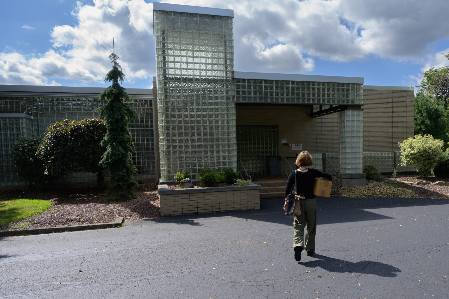 Rikke Foulke, paintings conservator at The Andy Warhol Museum, walks toward an office building where the RJ Lee Group is located.