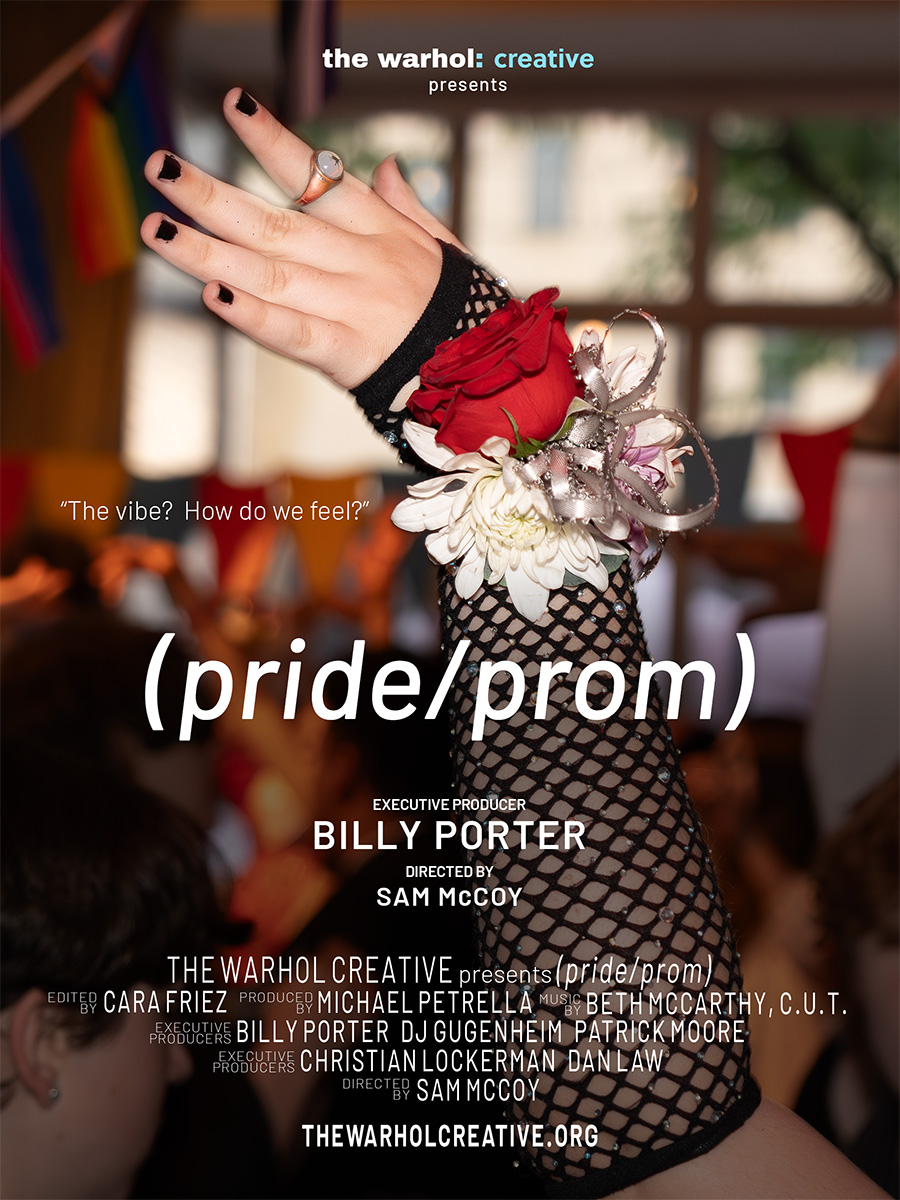 A movie poster for the film (pride/prom). The title appears overlaid on top of a picture of a teen’s arm, positioned to show off a colorful decorative flower corsage on their wrist. The corsage sits on top of their long fishnet gloves, and their fingernails are painted black, offset by a gold ring on one finger. In the background, it is clear that there is a large crowd of teens around them, though other faces and features remain indistinct.