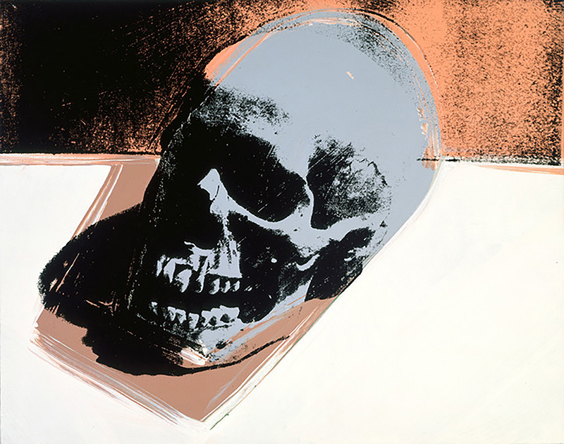 A screenprint of a dark grey skull facing to the left on a tan surface with a khaki background